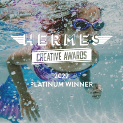hermes creative award logo overlaying girl swimming