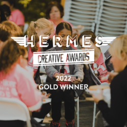 hermes creative award logo overlaying happy group of children