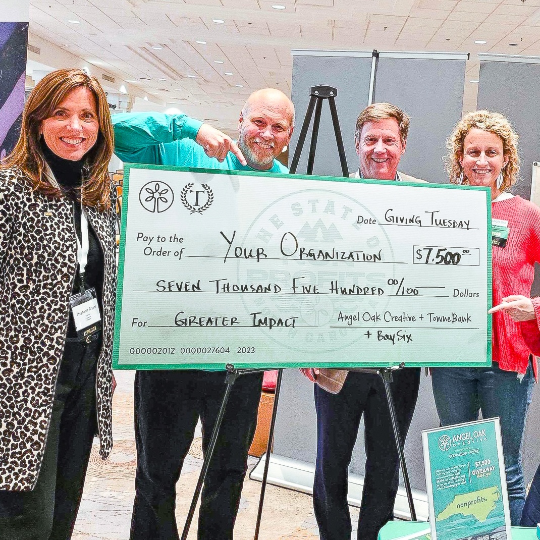 Angel Oak Creative presenting a large donation check