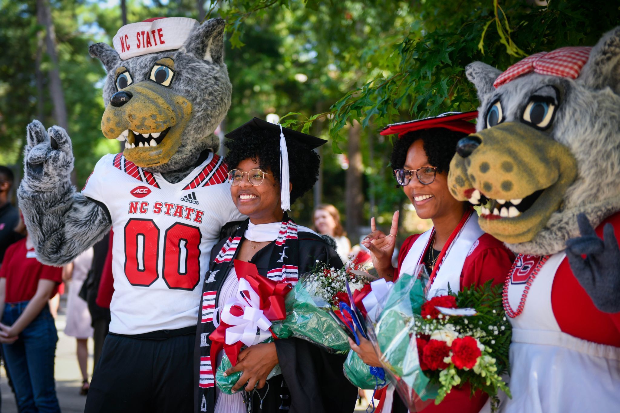 Kristin at NC State graduation with school mascots